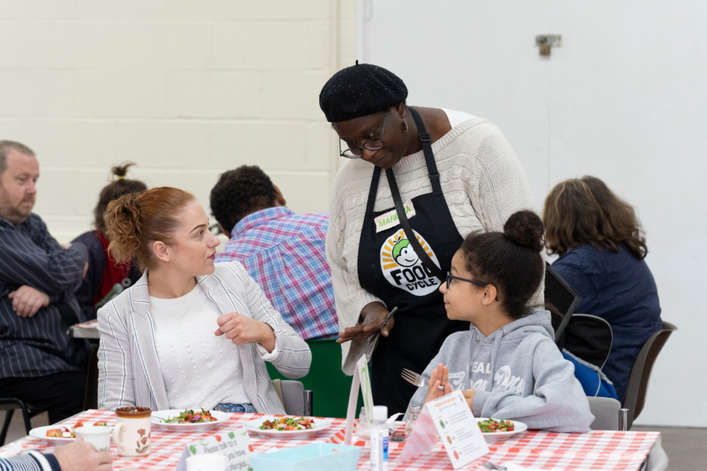 Adult and Child talking to FoodCycle volunteer