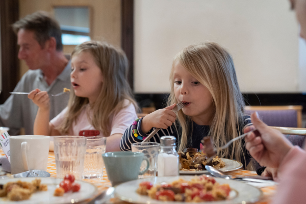 Kids eating at Community Meal