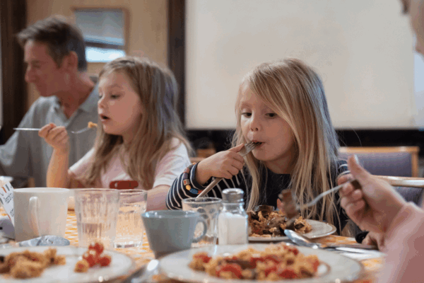 Kids eating at Community Meal