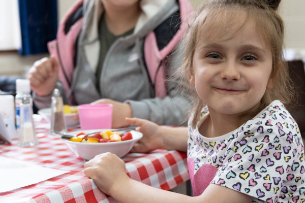 Child eating a community meal